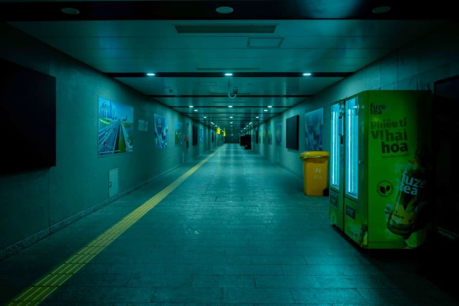 Empty underground hall with vending machine and advertisements in Ho Chi Minh City.