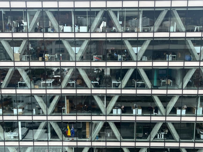 Office building facade with glass windows and geometric patterns in Bogota, Colombia.