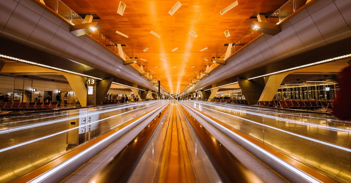 Passenger using self-service check-in kiosk at airport for convenient travel experience.