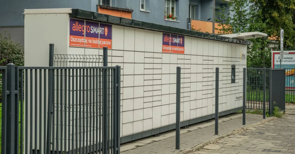 Outdoor parcel locker in Wroclaw, with Allegro Smart advertisement, near residential buildings.