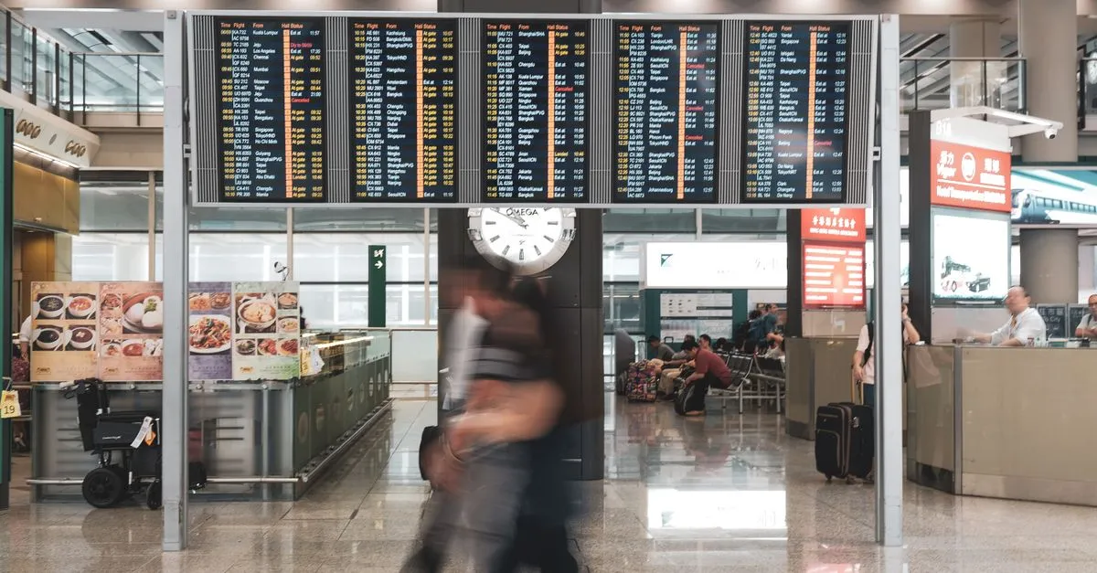 Passenger using self-service check-in kiosk at airport for convenient travel experience.