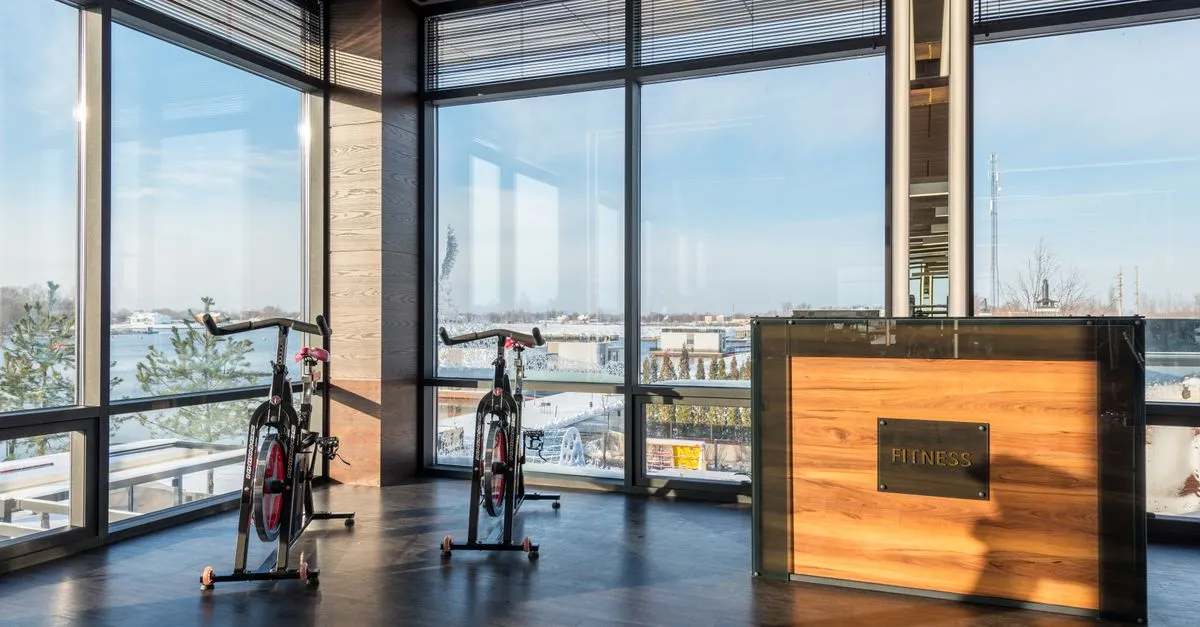 Yellow DHL Packstation under solar panels in Berlin, Germany, showcasing sustainable technology.